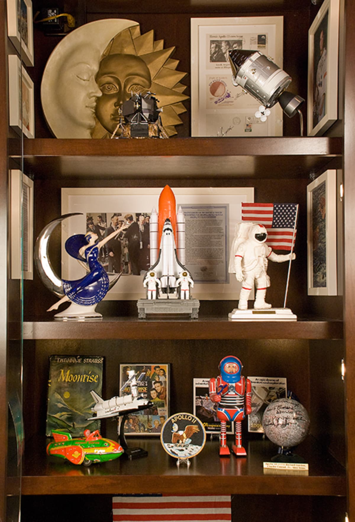 An image of a display case filled with moon, astronaut, rocket, and other outer space memorabilia.