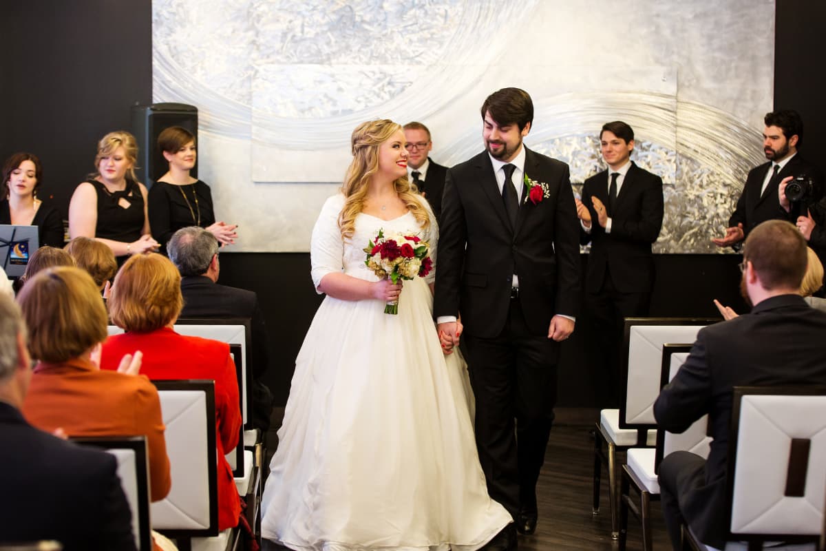 now husband and wife A married couple walk down the aisle after being pronounced married.