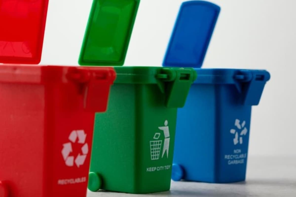 zoom in recycling bins Three different types of recycling bins. One red, one green, one blue.
