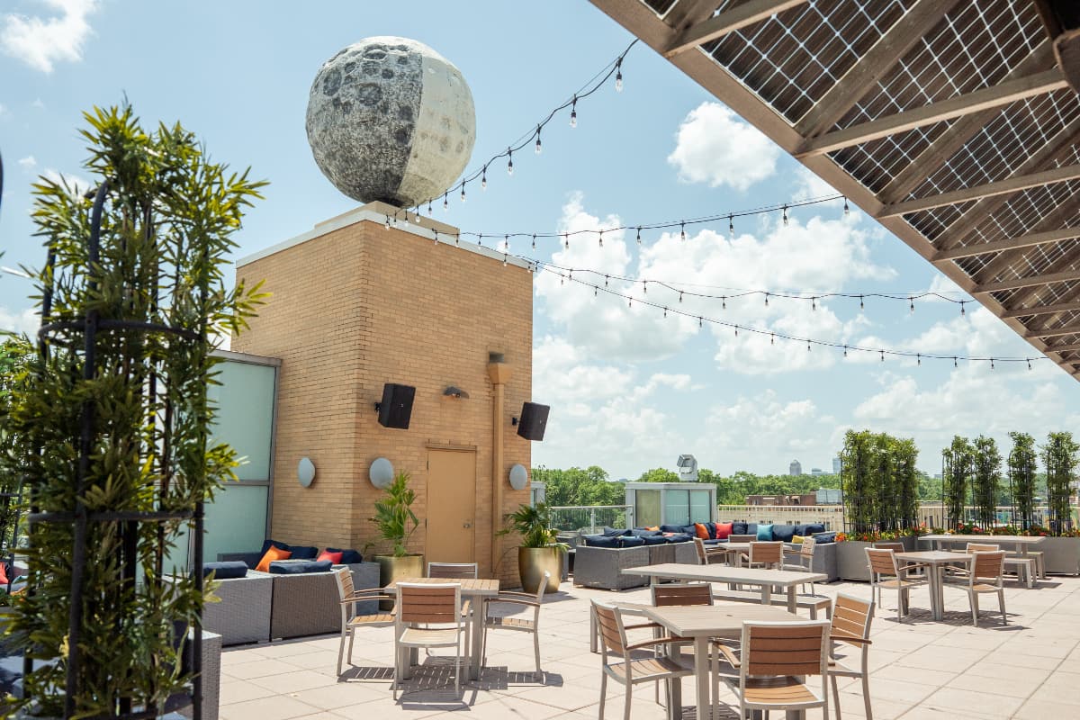 garden bar overview Seating options are shown beneath the giant statue of the rooftop moon statue